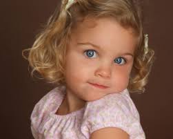 The likely eye color of your baby is brown or hazel and the likely hair colors will either be brown or black hair because these genes are all dominant. Little Girl With Big Blue Eyes And Curly Blonde Hair With Her Chin On Left Shoulder Spoiled Rotten Photography