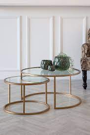 2 circular glass brass coffee tables