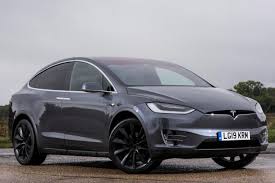 While the tesla model x is certainly distinctive to look at, with its rounded nose, swooping roofline and raised stance, we'd argue that it isn't as slick as the model s it's based of course the most unusual detail about the model x is the rear doors, which open outwards and upwards in a 'falcon wing' shape. New Tesla Model X 2021 Review Car Magazine