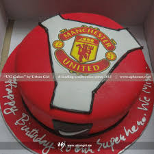 Chocolate cake with hand cut man utd logo, with matching vanilla cupcakes. Manchester United Inspired Design Cake