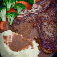 cook steak on stove with mashed potato