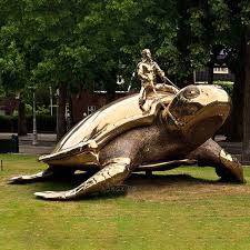 Man Riding Gold Turtle Steel Sculpture