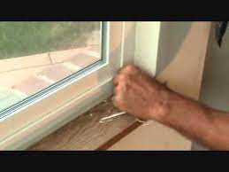 remove caulking around a window frame