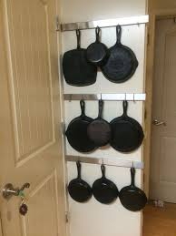 Cast Iron Pan Rack On The Wall Behind