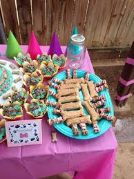 Celebrate your pup's birthday with a homemade cake that will make tails wag! Dog Table Topped With Treats Peanut Butter Covered Milk Bones And Decorated Bones From Petsmart Puppy Cake Dog Cakes Puppy Party
