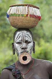 mursi woman with lip plate and basket