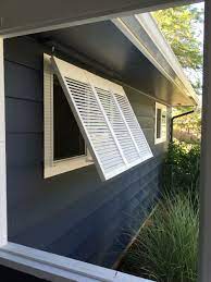 Bahama shutters act as a highly functional and a robust window covering option in southeastern american hurricane belt. Diy Removable Bermuda Shutter For West Facing Window From Reclaimed Louvered Closet Door Bermuda Shutters Shutters Exterior Bahama Shutters