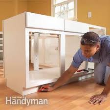 With most cabinets now installed with thin strips of composite wood there are a few tricks on how to install toe kick correctly.in this guide we'll show you how to layout, cut and install toe kick under your kitchen or vanity. How To Install Kitchen Cabinets Diy Family Handyman