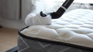 a mattress with a steam cleaner