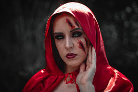 woman wearing red hood with makeup