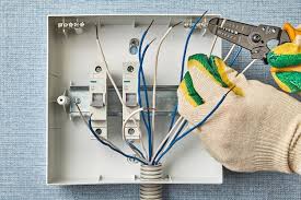 An Electrician Uses A Wire Stripper To