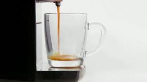 Coffee Maker Pours Coffee Into A Cup
