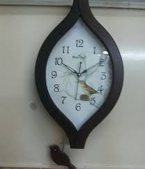 oval shape wooden color pendulum clock
