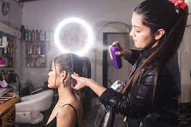 makeup artist spraying hairspray