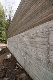 board formed concrete wall wood above