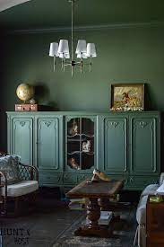 This amazing home office/library is painted in this dignified dark green paint color. Moody Green Study Salvaged Living