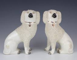 The dog is some type of a terrier with a white body, brown ears, a brown spot on his back, and brown tail. The Story Of The Staffordshire Dog Figurines Barnebys Magazine