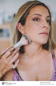 middle aged woman getting makeup done