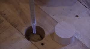 fill pipe holes in a hardwood floor