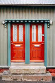 Two Orange Entrance Doors With Glass