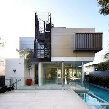 House With Outdoor Spiral Staircase Leading To Rooftop Deck