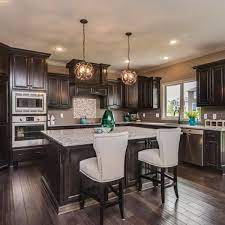 We custom build all of our solutions, meaning your unique cabinets will fit your unique home. Black Stained Kitchen Cabinets Iowa Remodels