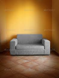 gray sofa on terracotta tiled floor in
