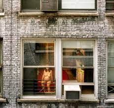 A woman naked at the window 