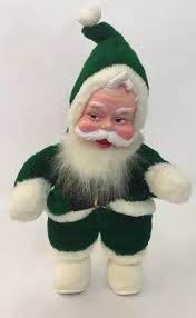 Patrick's day.santa had a green suit but when coca cola took him as an icon they changed his suit to be red because that's the colour of the coke bottle.santa is real btw. The Rushton Co Santa Claus Plastic Face Plush Rare Green Suit Doll Decor 16 Vintage Christmas Decorations