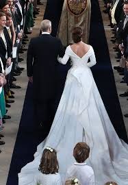 The silk gown featured long sleeves, a fitted bodice and a full, pleated skirt. Princess Eugenie Just Confirmed This Will Be The Biggest Wedding Trend Of 2019 Purewow