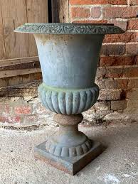 large antique cast iron garden urns in