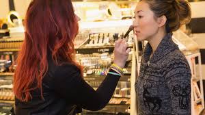 sephora makeup artist helping woman