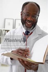 Portrait Of Doctor Reading Chart Stock Photo Masterfile