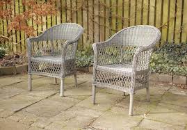 Two Outdoor Patio Chairs In A Garden Or