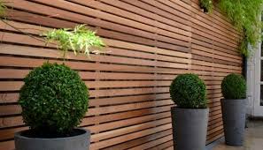 high horizontal wood fence to hide an
