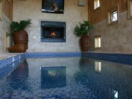 indoor pool with fireplace and tv