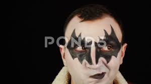 man in scary demon makeup with brown