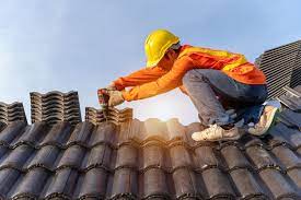 asian roofer working on roof structure