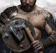 Viking tattoo the viking warriors were not only known for their power and brutality but also their fearful tattoos. Cropped Tattooed Male S Body With Vikings Shield And Axe Stock Photo Picture And Royalty Free Image Image 62832952
