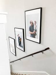 After suspending the picture on the hanger, remove the strip of tape, and use a level to check your 1.directly side by side 2.one up and the other slightly down 3.none of the above. How To Hang Photos On Your Staircase Love Renovations
