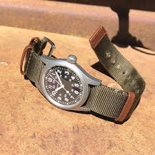 38mm matt stainless steel case, three hand display, dark dial with light, luminescent numerals, indexes showing hours and minutes, durable nato strap: Back To Basic With The Hamilton Khaki Field Mechanical Wrist Watch Review