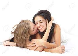 Blond Girl Touching And Kissing Kindly Her Girlfriend In The Bed. Stock  Photo, Picture and Royalty Free Image. Image 20772203.