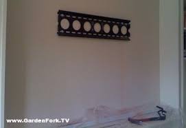 hang a tv on a brick or concrete wall