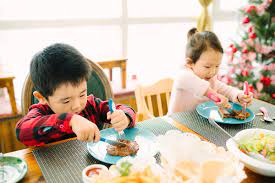 The meals are often particularly rich and substantial, in the tradition of the christian feast day celebration, and form a significant part of gatherings held to celebrate the arrival of christmastide. Kids Having Christmas Dinner At Home By Maahoo Studio Christmas Dinner