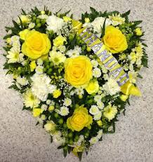 A colourful heart shaped wreath arrangement with a son name design and a bouquet of flowers. Loose Yellow And White Heart Buy Online Or Call 01206 843461