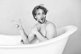 Premium Photo | Surprised man with muscular body sitting in bathtub. guy  with pointing finger in bath tub. spa and beauty, relax and hygiene,  healthcare, copy space. black white.