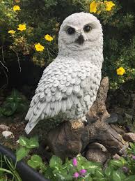 White Snowy Owl Figurine On Tree Stump
