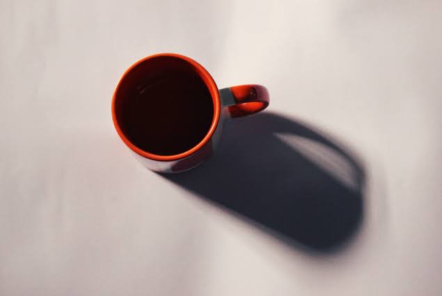 Mug blocks the light, making a shadow.