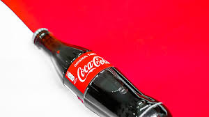 coca cola bottle on white table hd