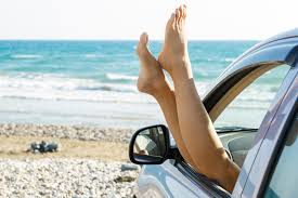 Female legs dangling from car window against sea 14402622 Stock Photo at  Vecteezy